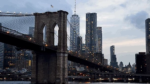 Concept image showing cryptocurrency symbols in a digital environmentBrooklyn Bridge and New York City skyline representing the scale of the state’s digital economy